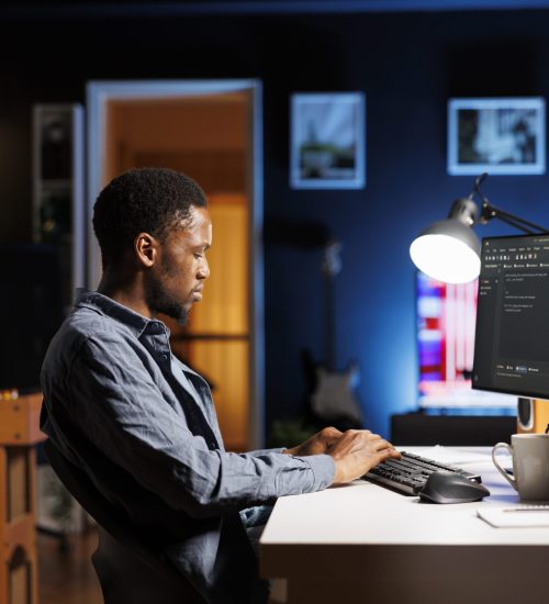 Male programmer working on developing new html script Male programmer working on developing new html script, typing binary code on terminal window. Young web developer does debugging work with coding language, database internet security.